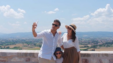 Resort Hotel Assisi com Padel Tennis Bike Hotel 3 swimming pools soccer field. Family taking a selfie with rural landscape background