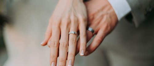 Deluxe room Woman's hand with engagement ring and man's hand with wedding band