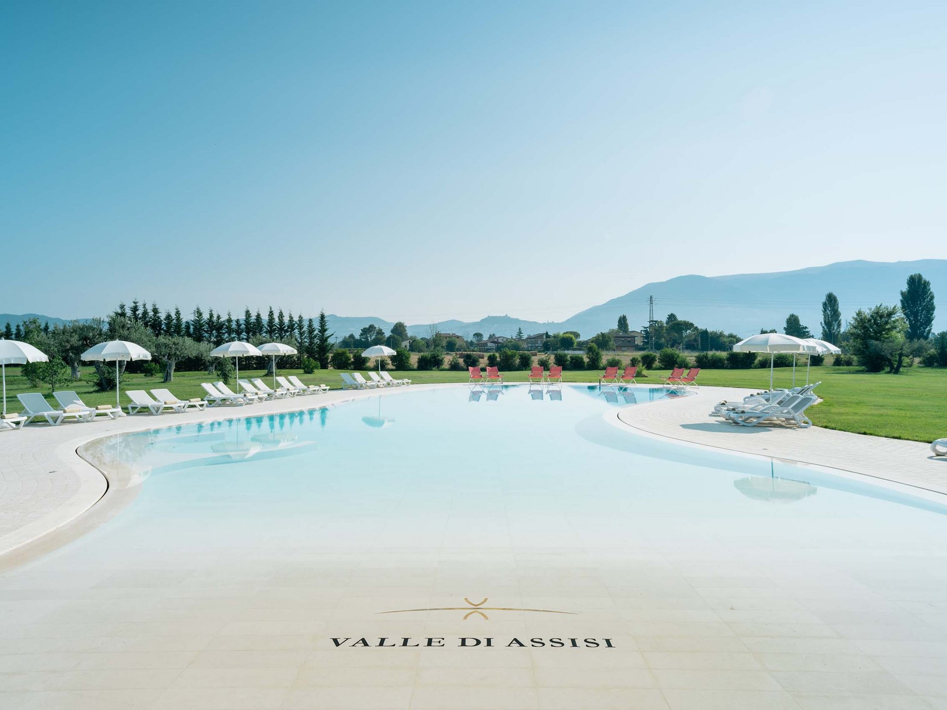 Deluxe room Outdoor pool with sun loungers and umbrellas at Valle di Assisi